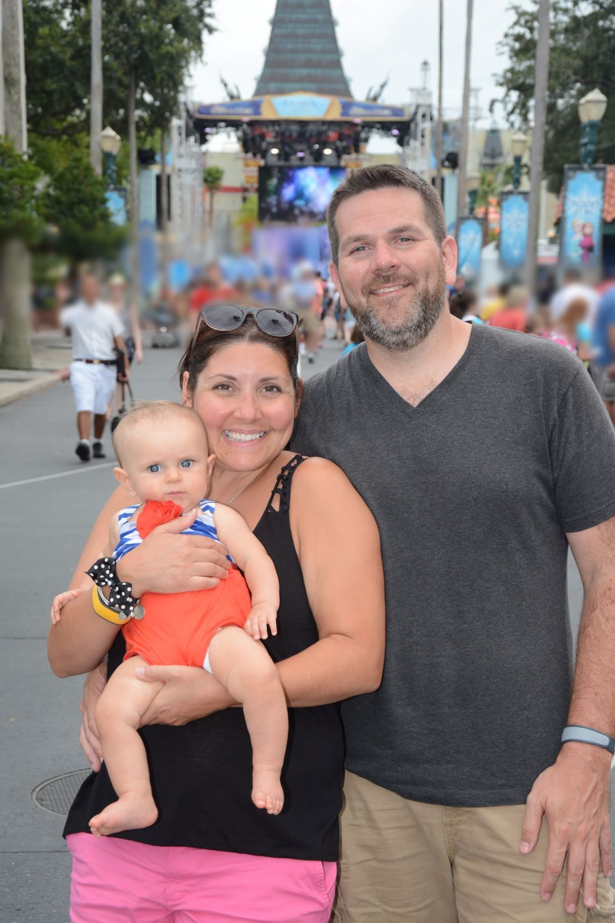 Carrolyn holds baby Victoria beside Bill on Hollywood Boulevard at Disney's Hollywood Studios.
